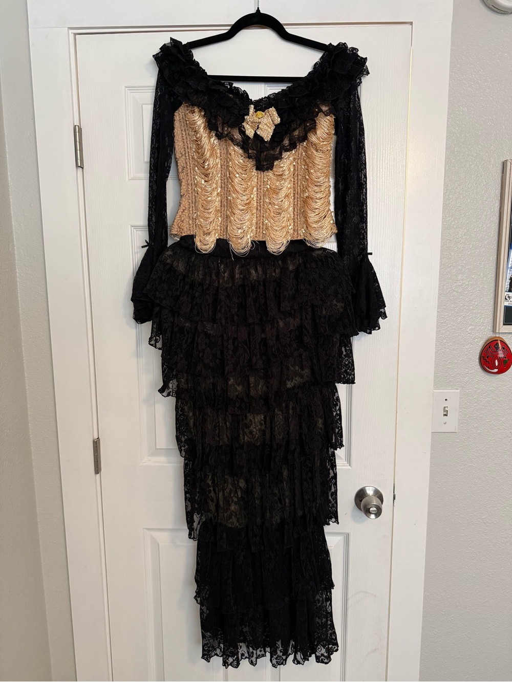 Elegant Black Lace Tiered Long-Sleeve Dress with Gold Bodice